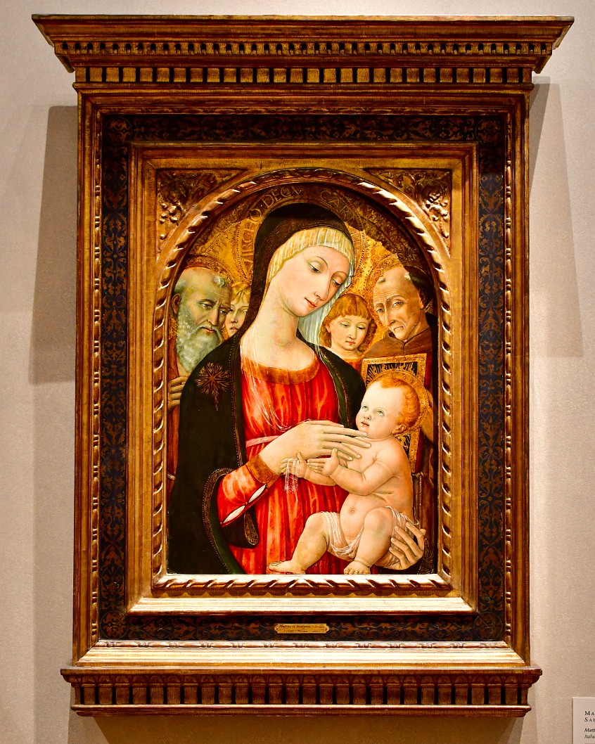 Madona and Child With Saints and Angels Inside of an Ornate Frame